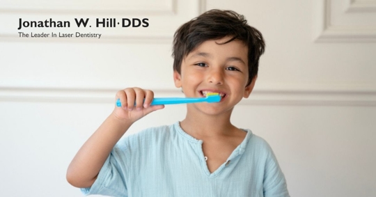 young boy brushing teeth