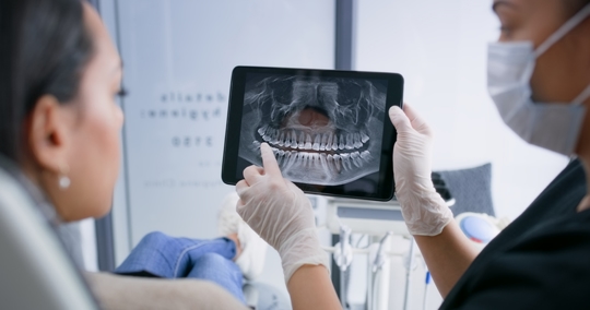 Description Hands, tablet and teeth xray, dentist and patient